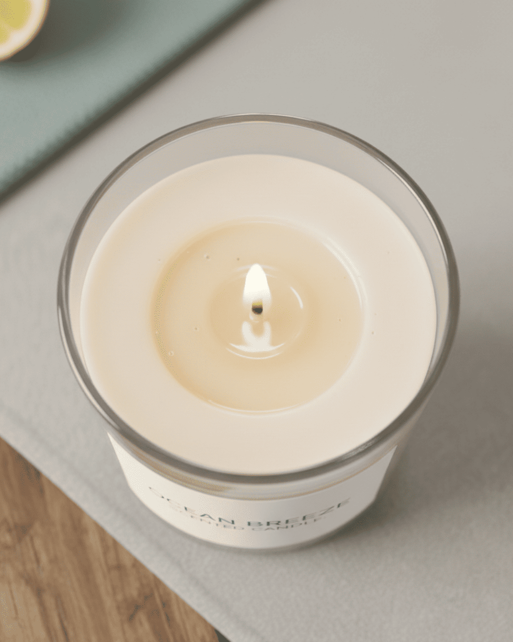 Candle in a glass jar with a white label on a wooden surface